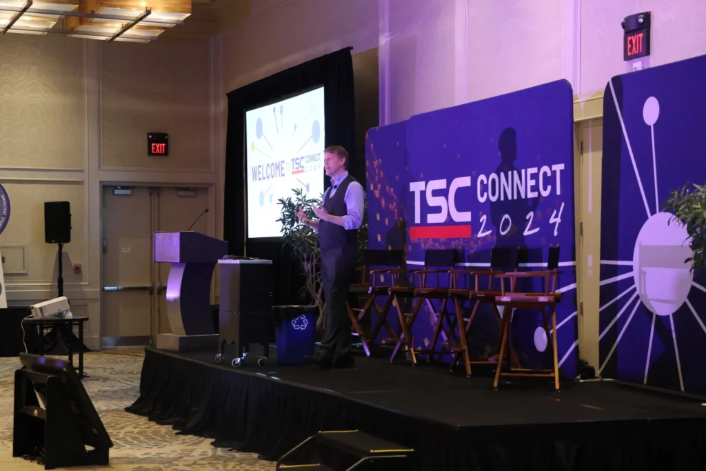 Branded fabric table cover and banner at an event booth