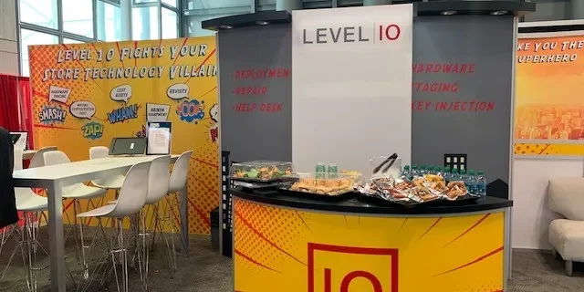 Professional installation of custom SEG fabric graphics for a booth at McCormick Place convention center