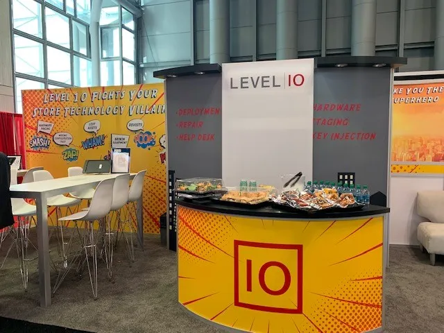 Professional installation of custom SEG fabric graphics for a booth at McCormick Place convention center